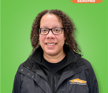 female employee smiling wearing a black SERVPRO jacket