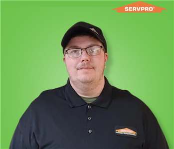 male employee wearing a black SERVPRO shirt and hat