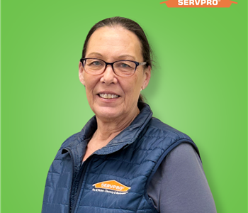 female employee smiling and wearing a blue SERVPRO vest