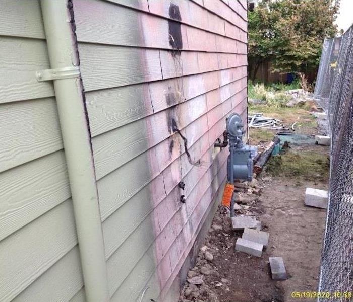 Exterior smoke residue on the side of a home