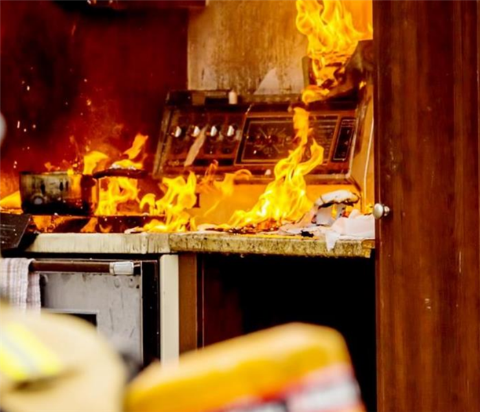 a kitchen on fire with flames everywhere