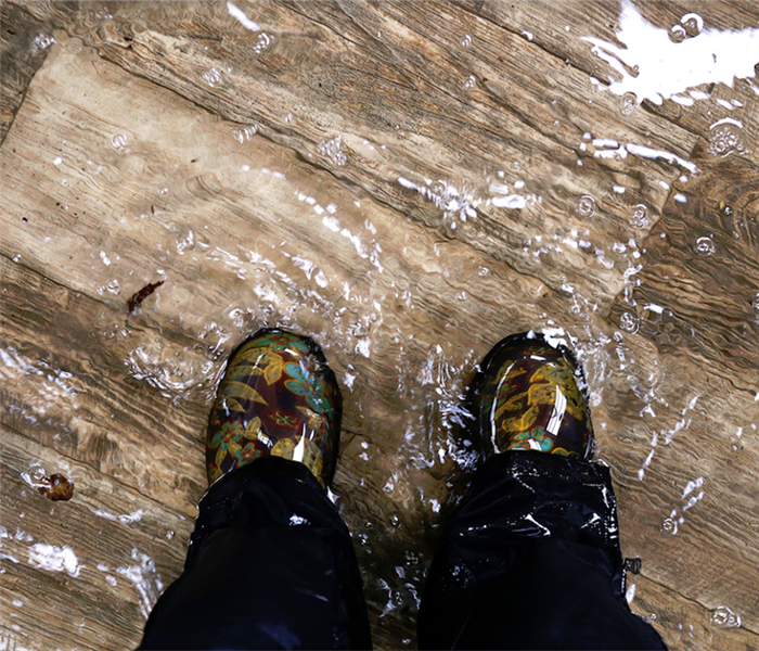 a person standing in a room flooded with water
