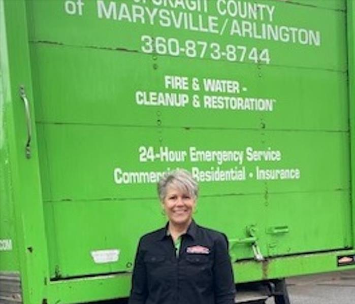 SERVPRO employee standing in front of a work vehicle
