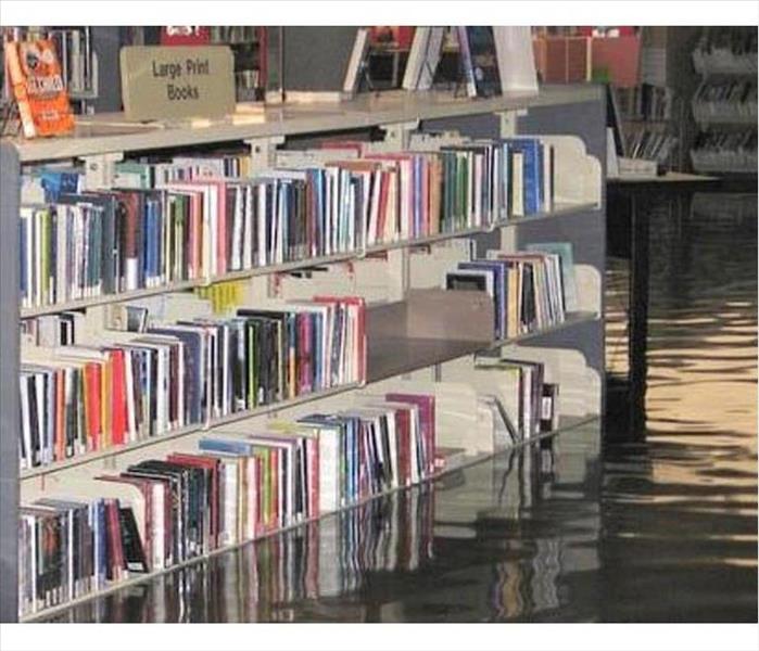 book case in library with flooded floor