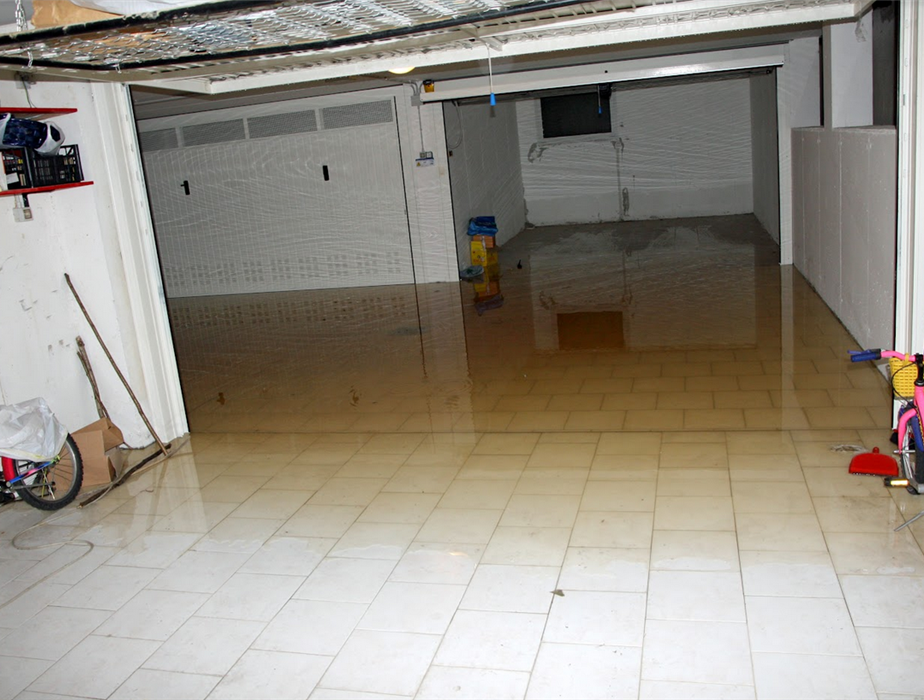 a flooded garage with water covering the floor all the way up to the door