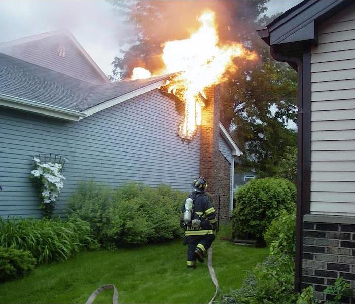 Fireman outside of home on fire