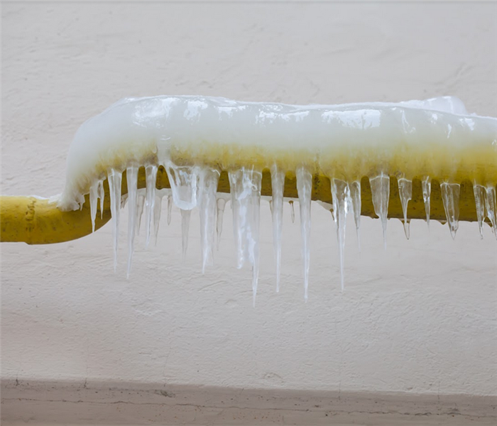 icicles hanging off of a frozen pipe