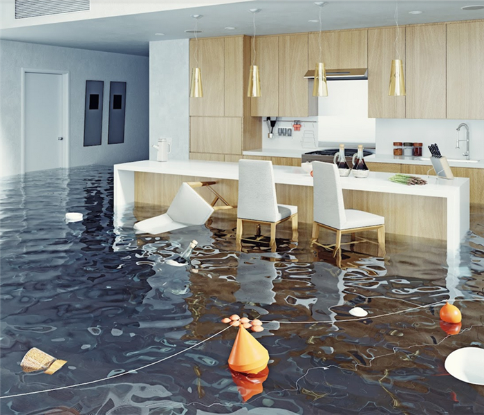 a flooded kitchen with water everywhere and things floating around
