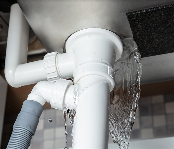 a pipe leaking water under a sink