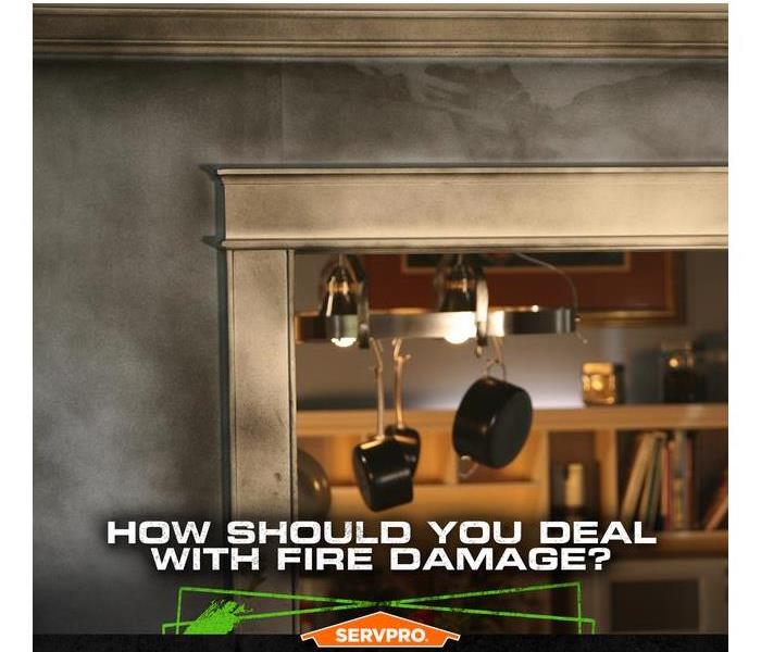 Soot and smoke damage on the walls and molding entering a kitchen with he caption: HOW SHOULD YOU DEAL WITH FIRE DAMAGE?