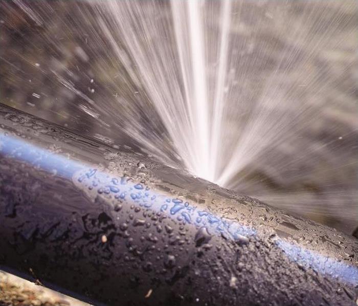 water spewing from hole in pipe